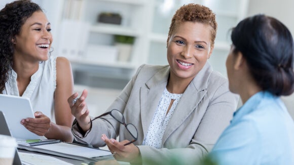 three women in meeting talking