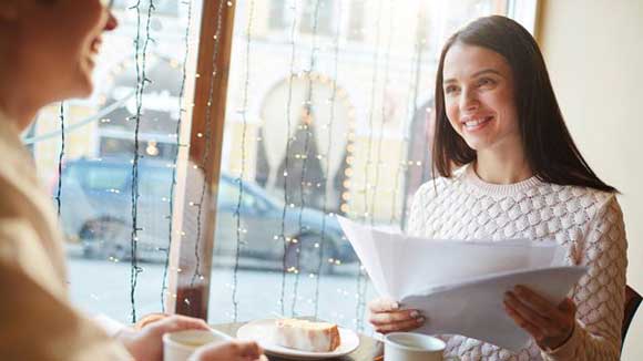 woman in coffee house looking at ways to avoid bad hires