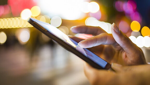 Man standing on the street on a tablet