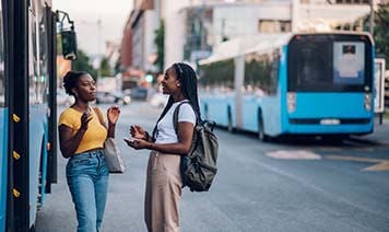 Women talking near bus