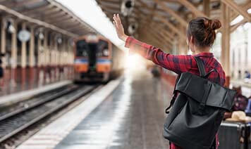 Woman putting hand out to signal at a train
