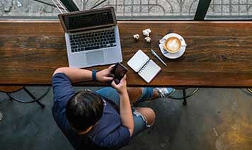 man with devices with coffee