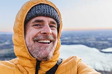 man smiling on mountain