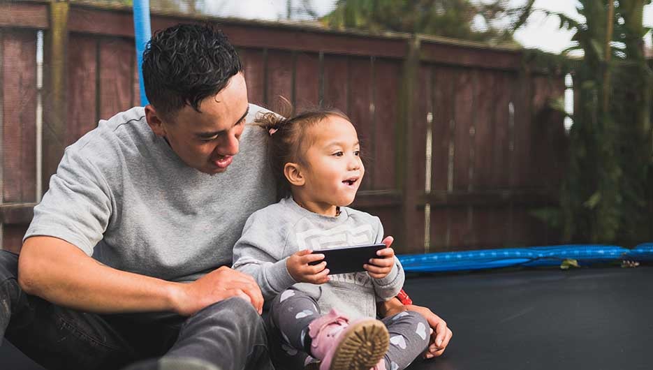 father and daughter on trampoline