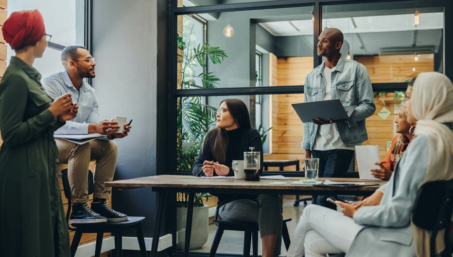 people talking around work table