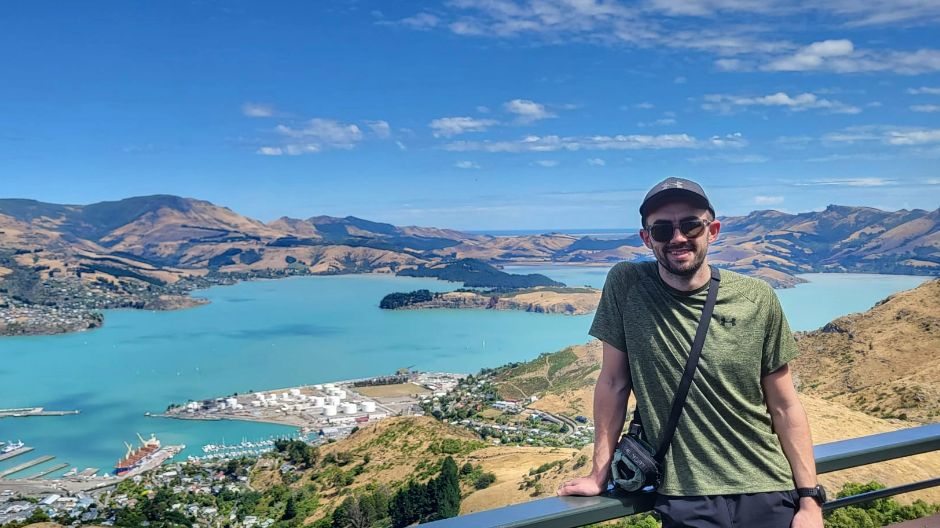 Man posing in front of scenic background