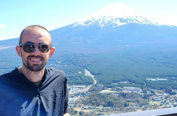 Man posing in front of scenic background